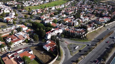 Aerial-top-down-of-driving-cars-on-highway-in-suburb-district-of-Puebla