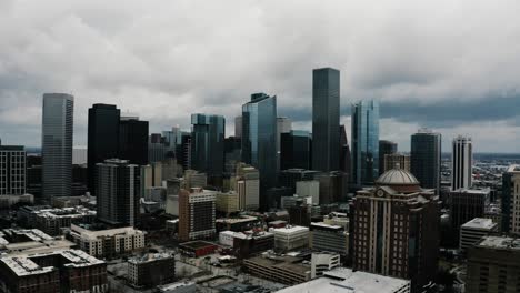 Drone-shot-flying-towards-the-Houston,-Texas-skyline-on-a-stormy-day