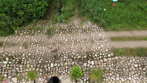 brook-stone-dirt-road-water-lock-water-lake-aerial-dolly-flight