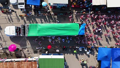 Vista-Aérea-De-Arriba-Hacia-Abajo-Desciende-Sobre-Una-Carroza-De-Carnaval-Durante-La-Gran-Marcha-En-Curazao-Con-Artistas-Bailando