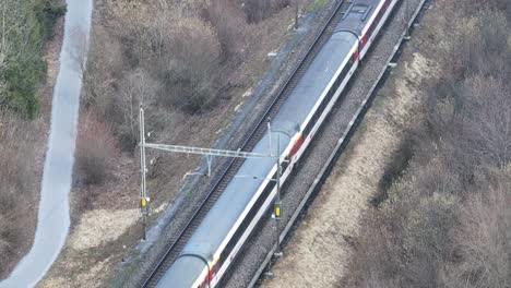 Trains-converge-on-parallel-tracks-in-Swiss-landscape