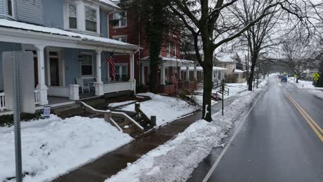 Blue-house-in-american-neighborhood-with-american-flag-in-entrance