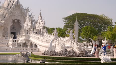 Tourists-walking-around-temple-grounds-of-White-Temple