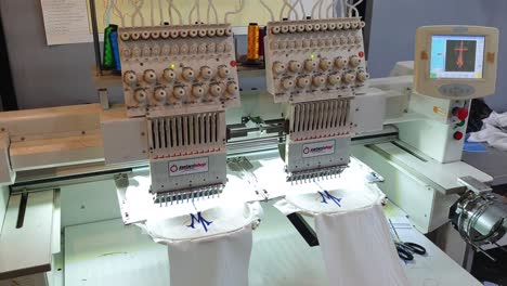 View-of-computerized-textile-embroidery-machine-automatically-embroidering-pattern-design-onto-textile-within-fashion-clothing-industry