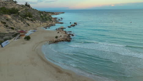Sandy-Konnos-Beach,-Ayia-Napa,-Cyprus-during-sunset,-aerial-view