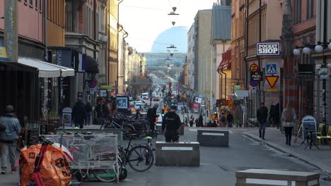 People-move-on-street-in-Stockholm-with-Avicii-Arena-in-background