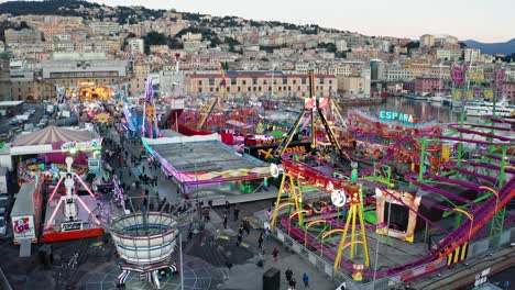 Illuminated-rides-at-Genoa-Winter-Park-at-city-waterfront,-Ponte-Parodi