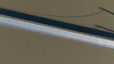 Aerial-spiral-shot-above-the-newly-constructed-suspension-pedestrian-bridge