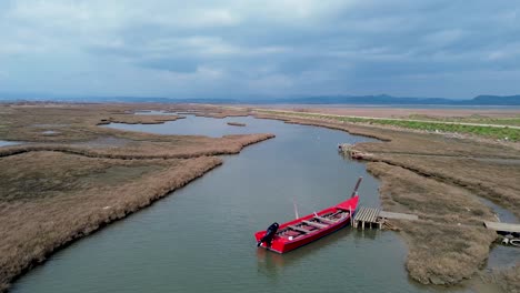 Aerial-Shot-of-Red-Boat-in-Delta-Evros-River,-Quiet-autumn-day,-4K-Footage