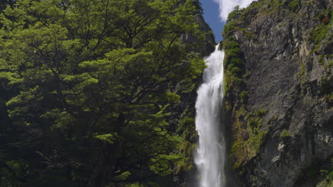 4K-footage-of-the-top-of-the-Devil's-Punchbowl-waterfall,-surrounded-by-forest---Arthur's-Pass,-New-Zealand