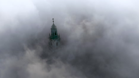 Aerial-view-of-Wawel-Castle-during-foggy-sunrise,-Krakow,-Poland