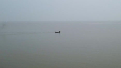 Kuakata-Beach-and-Small-Engine-Boat-Heading-Out-to-Fish-at-Sea-on-Calm-Waters