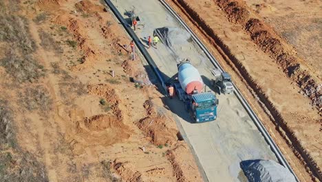 Yarrawonga,-Victoria,-Australia---8-March-2024:-Construction-workers-with-concrete-truck-forming-new-roadside-kerbs-in-Yarrawonga