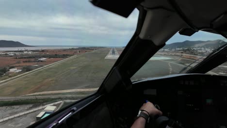 Immersive-pilot-FPV-POV-real-time-landing-at-Ibiza-airport,-Spain,-in-a-clouded-and-windy-winter-morning-with-moderate-turbulence