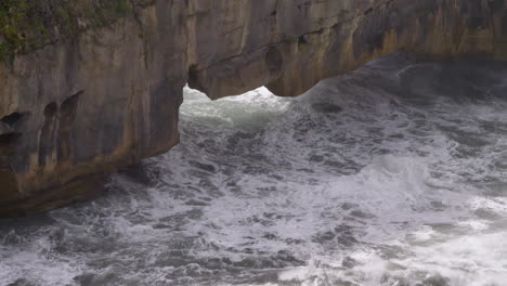 4K-footage-of-waves-rolling-under-a-sea-arch-----Punakaiki,-New-Zealand