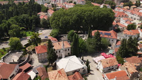 Trebinje,-Bosnia-and-Herzegovina,-drone-aerial-view-of-old-town,-stone-buildings-rooftops-on-sunny-summer-day---drone-shot