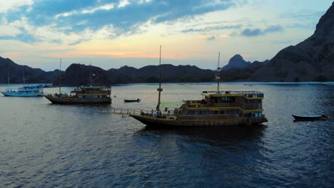 A-cruise-ships-anchored-off-the-coast-of-Padar-Island,-near-Komodo-in-Indonesia,-captured-from-a-drone-during-the-evening