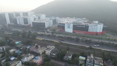 Sunrise-Shot-Of-Buildings-Near-A-Highway-Filled-With-Cars-And-Traffic-In-Chennai-City
