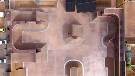 Top-down-shot-over-a-busy-skatepark-with-people-doing-stunts-in-Montpellier