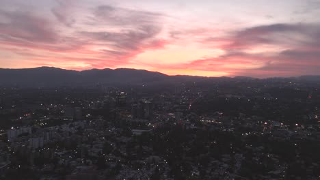 Southern-reaches-of-Mexico-City,-a-mesmerizing-sunset-casts-vibrant-orange-colors