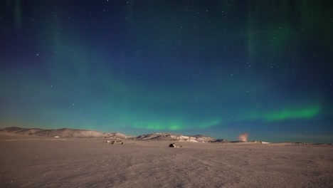 Against-a-blueish-backdrop,-flickering-greenish-Northern-Lights-sway-in-a-circular-dance