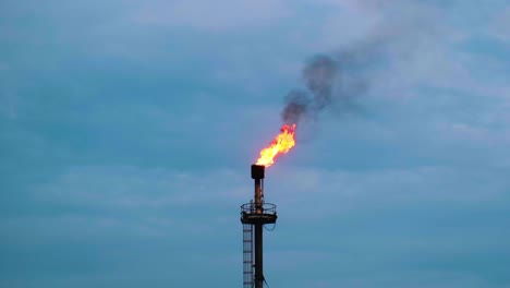 Industrial-petrochemical-exhaust-chimney-smoking-flame-burning-excess-gas-emission