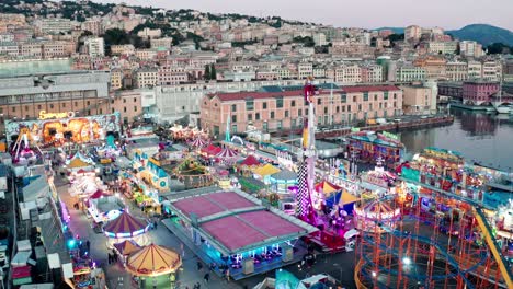 Illuminated-neon-lights-of-funfair-rides-at-Genoa-Luna-Park-on-waterfront