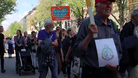 Elderly-protesters-march-at-climate-rally-in-Stockholm,-static-slomo