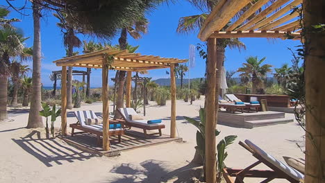 Empty-Beach-Resort-on-Hot-Sunny-Day,-Cabanas-and-Sunbeds