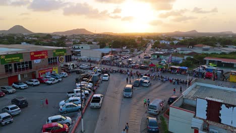 Families-wait-seated-on-edge-of-barricaded-road-for-Carnaval-Grand-March-at-sunset-in-Curacao