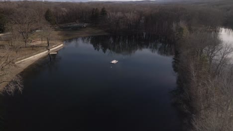 A-Lake-view-from-the-sky-while-panning-downward-over-a-dock