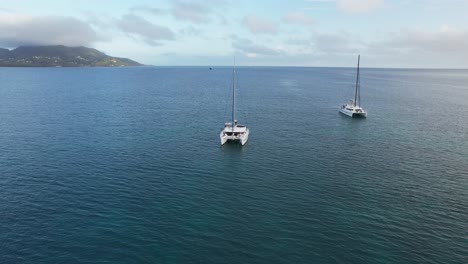 Several-catamarans-anchor-off-the-island-of-Praslin-in-the-Seychelles