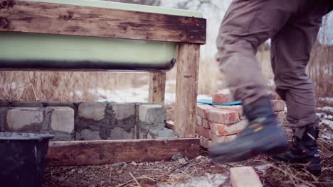 Skilled-Man-Bricklaying-Under-DIY-Hot-Tub