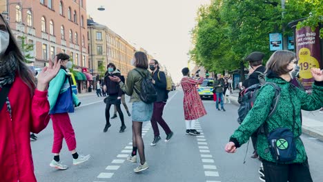 Protesters-dance-in-street-in-Stockholm-at-environmental-demonstration