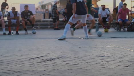 Slow-Motion-Courtside-View-of-Quick-Build-Up-and-One-Touch-Goal-During-Golden-Hour-at-Street-Soccer-Tournament