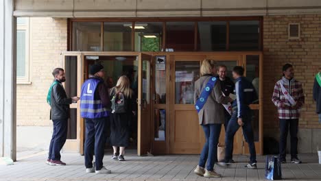 Voters-go-in-and-out-of-polling-station-on-election-day-in-Sweden