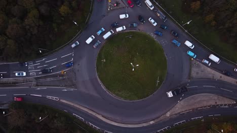 Aerial-Top-Down-above-junction-asphalted-road,-intersection-with-cars-driving-by-traffic,-town,-traffic-jam-at-daily-routine,-urban-city-lifestyle