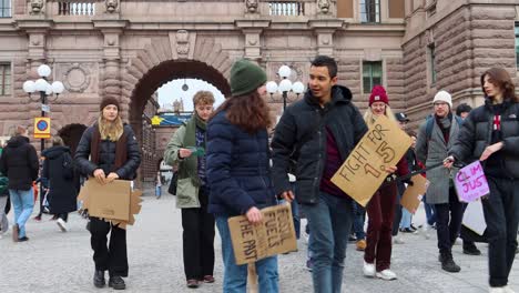 Fridays-for-Future-climate-protesters-walk-with-signs-in-Stockholm