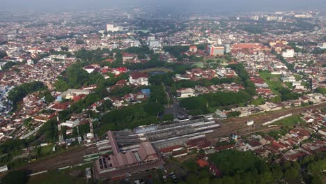 The-narrow-green-spaces-around-the-tracks-of-Malang's-biggest-railway-station-are-squeezed-by-growing,-crowded,-and-slum-area