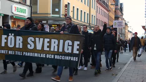 Swedish-protesters-march-with-banner,-rally-against-Covid-regulations