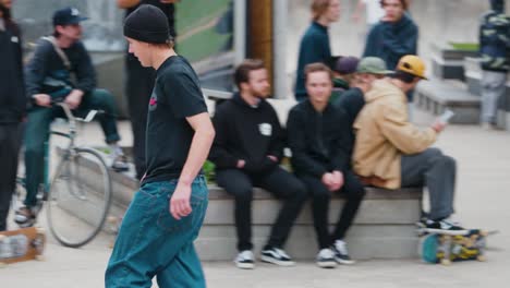 A-Teenager-Crashes-a-Trick-Skating-a-rail-on-his-Skateboard-at-an-outdoor-skate-park