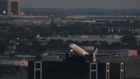 Evening-at-the-Toronto-airport,-plane-taking-off-with-its-lights,-heading-into-the-air