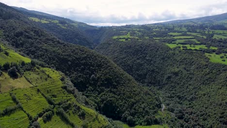 downhill-film-clip-of-a-canyon-with-lush-green-meadows-against-the-backdrop-of-the-Rumiñahui-volcano,-Puichig,-Parish-of-Machachi,-Province-of-Pichincha,-Ecuador