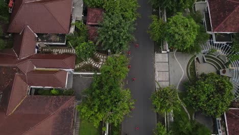 Aerial-view-of-streets-and-houses,-several-people-can-be-seen-running-happily