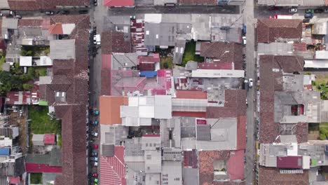 Top-down-aerial-view-of-houses,-rooftops-in-small-town-Filandia,-Colombia