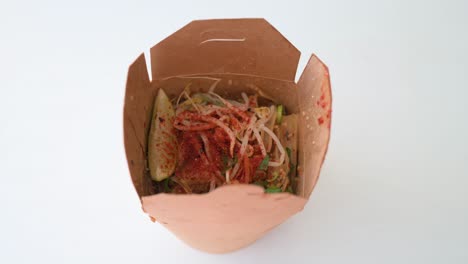 View-of-a-Thailand-cuisine-Pad-Thai-dish,-a-stir-fried-rice-noodle-meal,-in-a-take-out-delivery-box