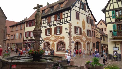 French-People-Pass-the-Fountain-in-the-Center-of-Kayserberg-Village