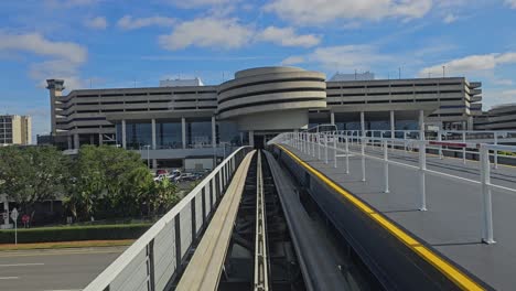 View-out-front-window-of-automated-guideway-transit-people-mover-system-traveling-to-main-terminal