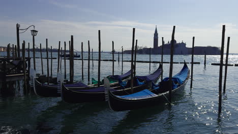 Traditional-Venetian-Gondolas-floating-in-Grand-Canal-with-background-of-Church-of-San-Giorgio-Maggiore