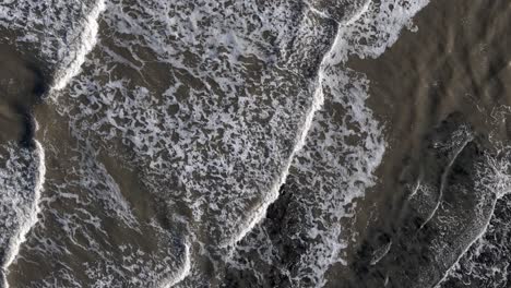 Aerial-shot,-bird-eye-view-of-waves-crashing-in-the-north-sea-off-scarborough